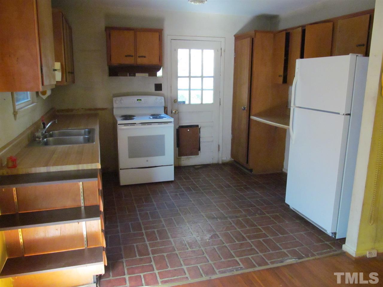 3417 Cheyenne Road Raleigh, NC 27609 - Photo 5 of 25 a kitchen with a refrigerator sink stove and cabinets