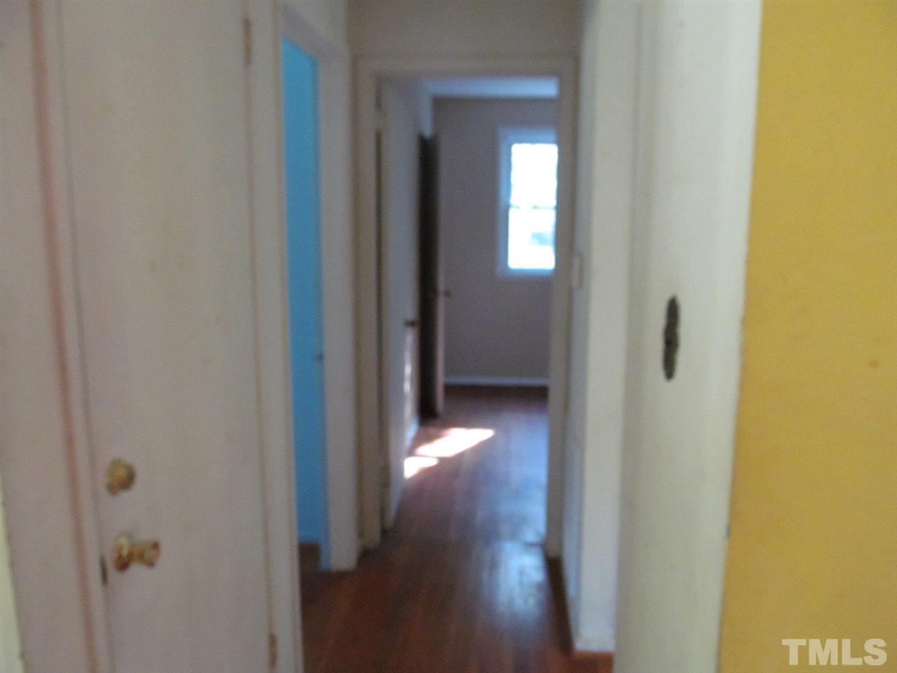 3417 Cheyenne Road Raleigh, NC 27609 - Photo 7 of 25 a view of a hallway with wooden floor