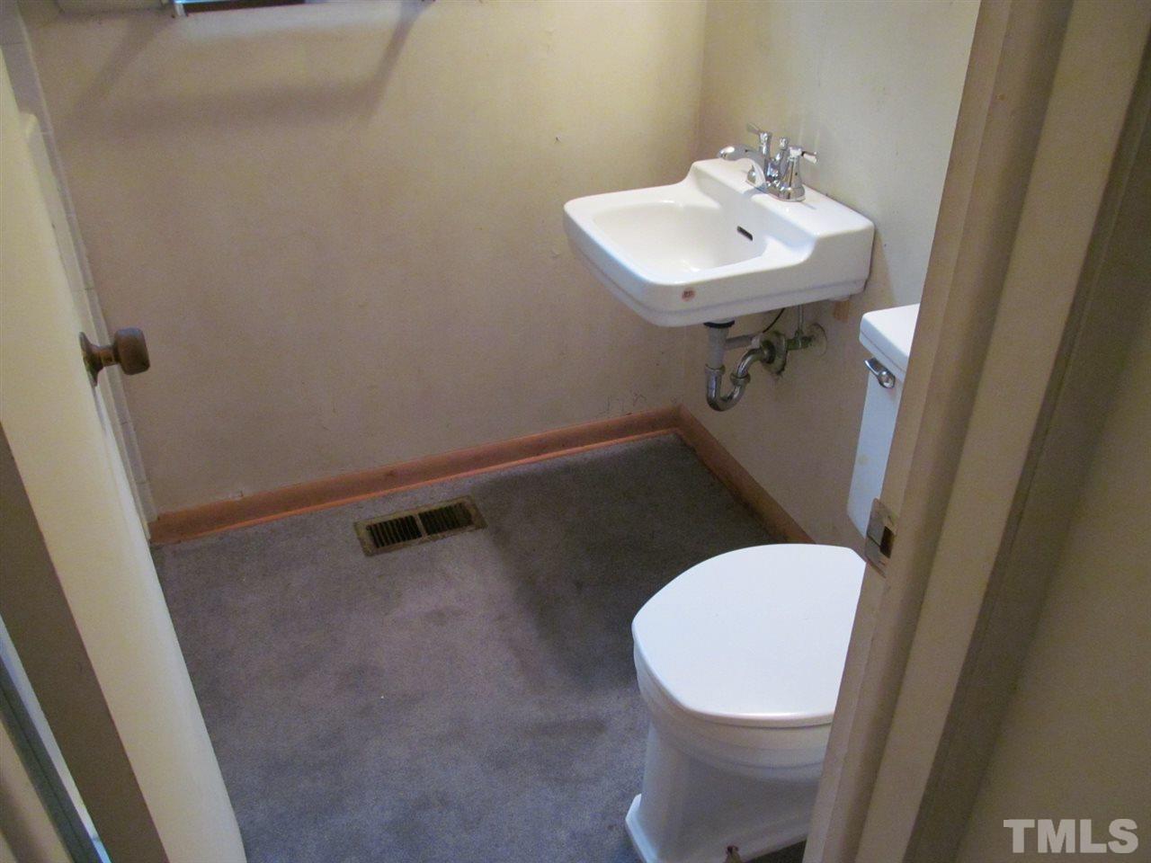 3417 Cheyenne Road Raleigh, NC 27609 - Photo 8 of 25 a bathroom with a sink a toilet and a mirror