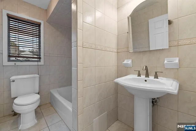 a bathroom with a sink toilet and mirror