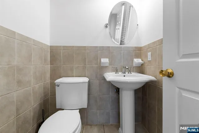 a bathroom with a toilet sink and mirror