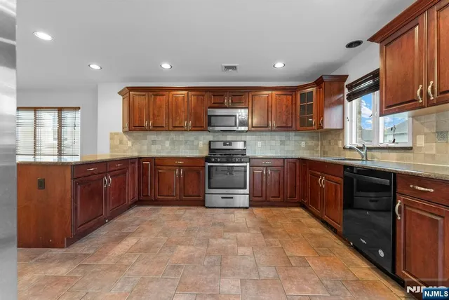a kitchen with stainless steel appliances and cabinets