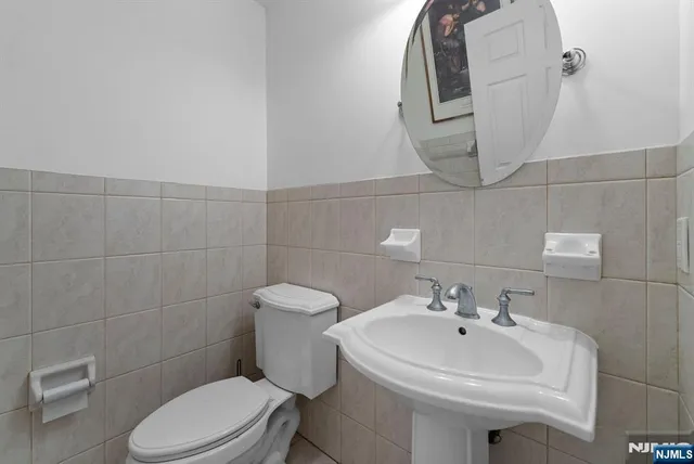 a bathroom with a sink toilet and mirror