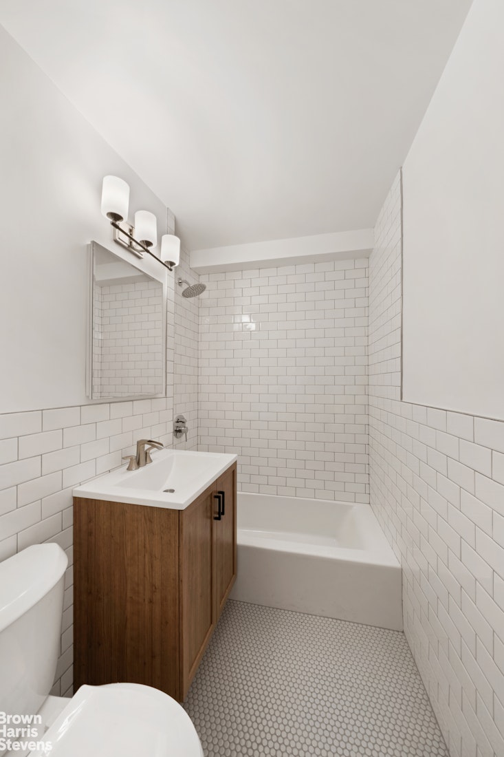 98-41 64th Road, Unit 3G Queens, NY 11374 - Photo 7 of 14 a bathroom with a sink mirror toilet and bathtub