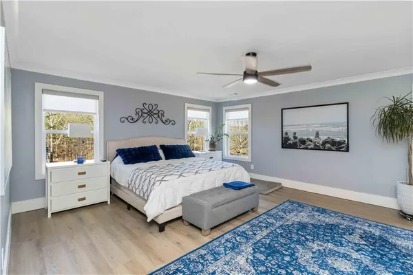 a bedroom with a large bed and a chandelier