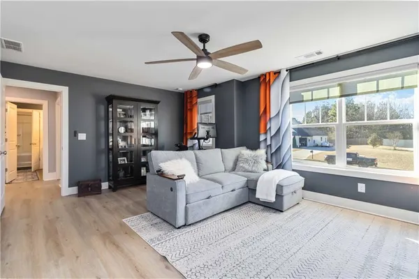 a living room with furniture and a large window