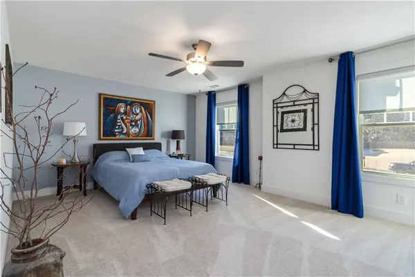 a spacious bedroom with a bed dresser and a window