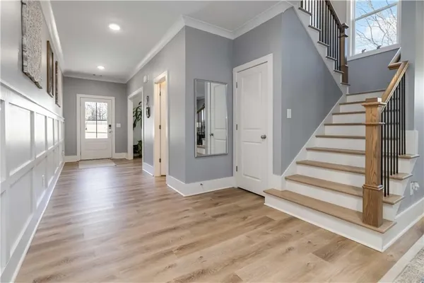 a view of a hallway with wooden floor and entryway