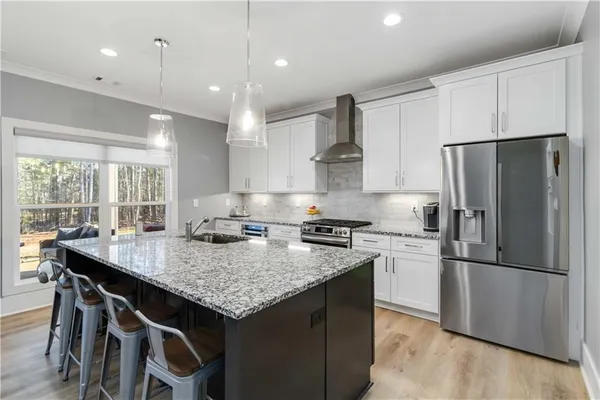 a kitchen with a stove a refrigerator and a sink