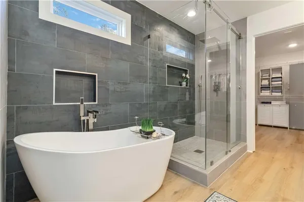 a bathroom with a bathtub and shower