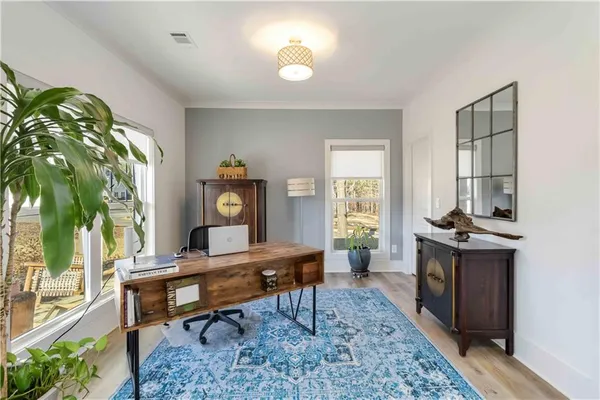 a room with furniture a chandelier and a rug