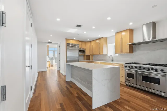 a kitchen with granite countertop a stove and a sink