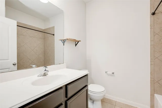 a bathroom with a sink toilet and a mirror