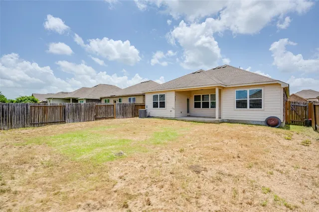 a front view of a house with yard patio and barbeque oven