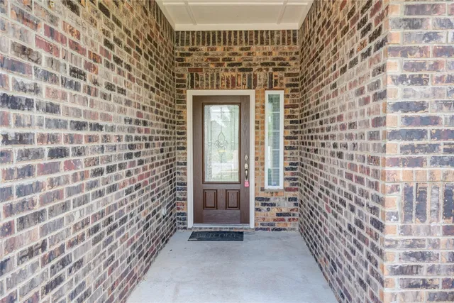 a view of a brick house with an outdoor space