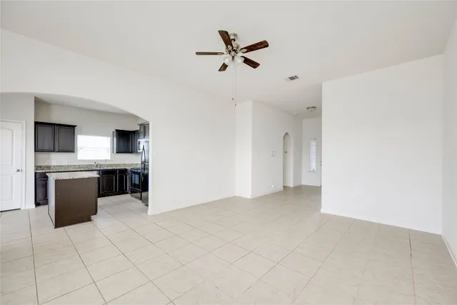 a view of kitchen with stainless steel appliances a refrigerator and a stove top oven