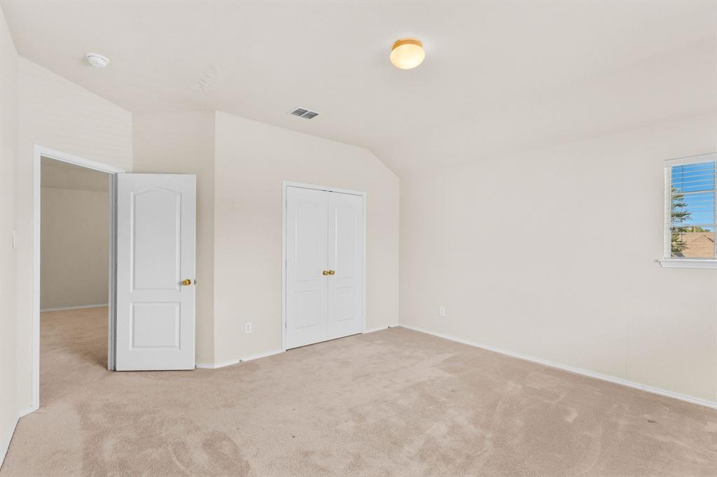2700 Hereford Road Denton, TX 76210 - Photo 26 of 36 Carpeted room featuring a window with blinds, a bi-fold closet door, and a paneled interior door