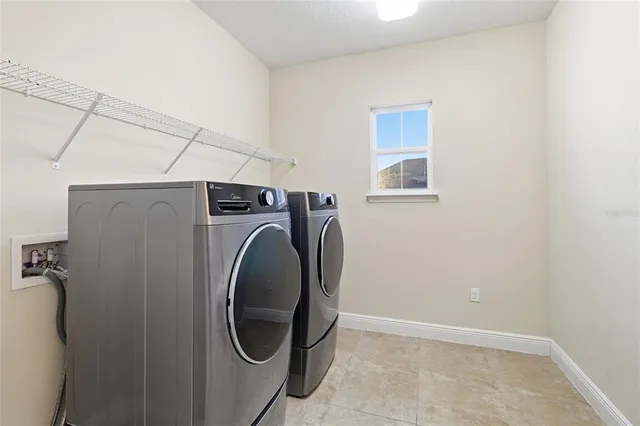 an empty room with chandelier fan