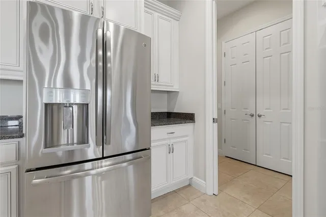 a large kitchen with stainless steel appliances granite countertop a lot of counter space and a sink