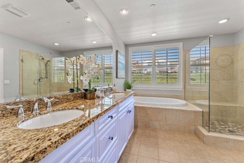 23 Vivido Street Rancho Mission Viejo, CA 92694 - Photo 16 of 44 a bathroom with a granite countertop sink and a large mirror