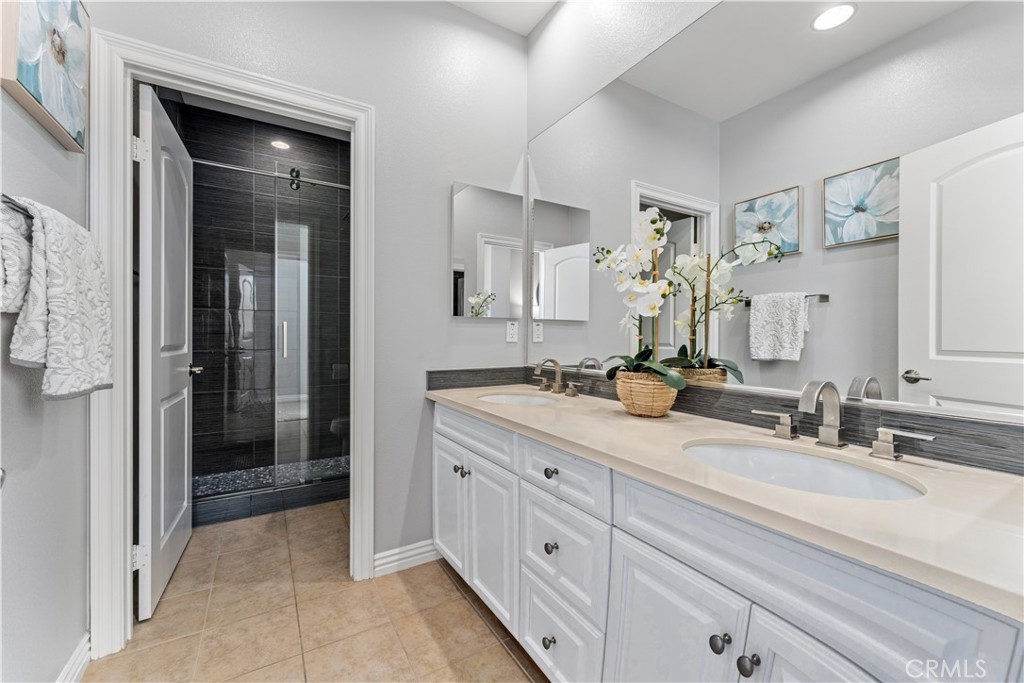 23 Vivido Street Rancho Mission Viejo, CA 92694 - Photo 21 of 44 a bathroom with a double vanity sink and mirror