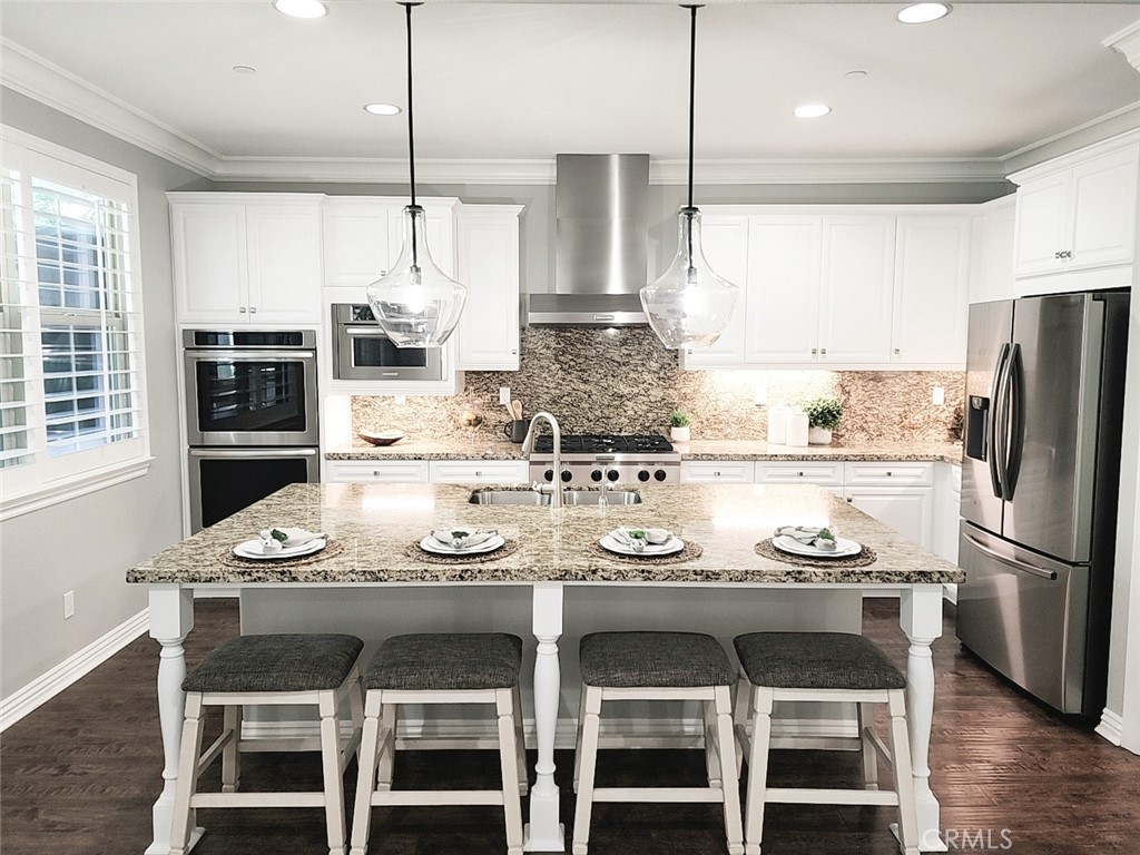23 Vivido Street Rancho Mission Viejo, CA 92694 - Photo 10 of 44 a kitchen with stainless steel appliances granite countertop a sink and a refrigerator