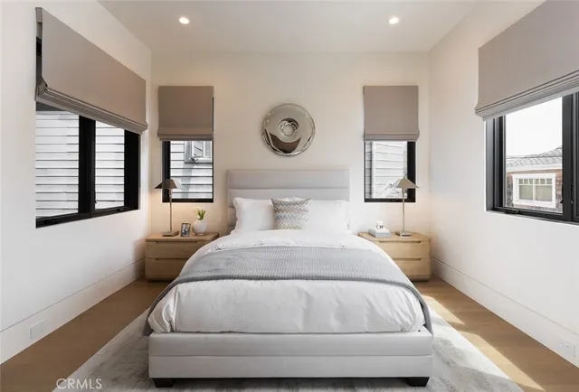 a bedroom with a bed and a large window