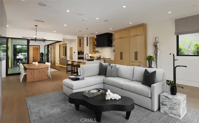a living room with furniture a rug and a chandelier