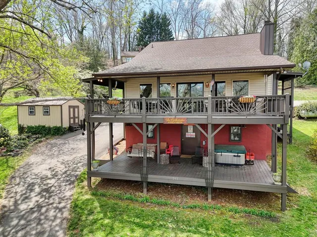 an aerial view of a house with swimming pool and sitting area