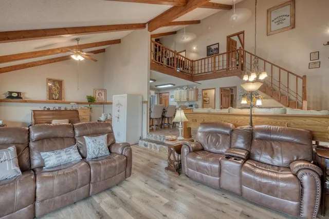a view of a dining room with furniture and a chandelier