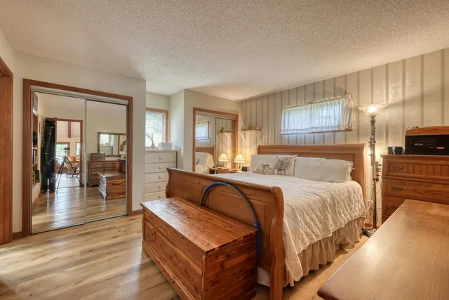 a bedroom with a large bed and a large mirror