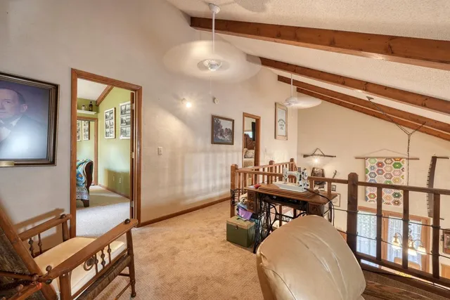 a spacious bedroom with a bed and a mirror