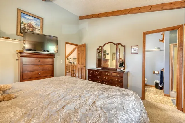 a bedroom with a bed and lamp