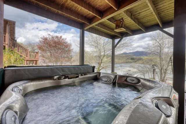 a view of house with backyard and lake view