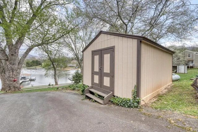 a view of a patio with table and chairs with wooden floor and fence