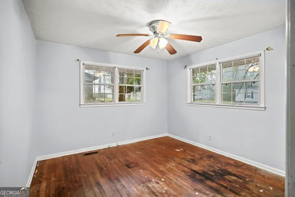 a view of empty room with wooden floor