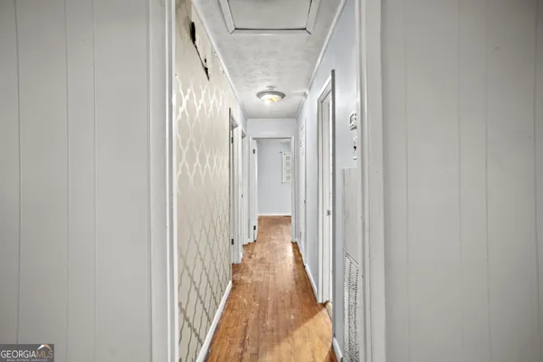 a view of a hallway with wooden floor