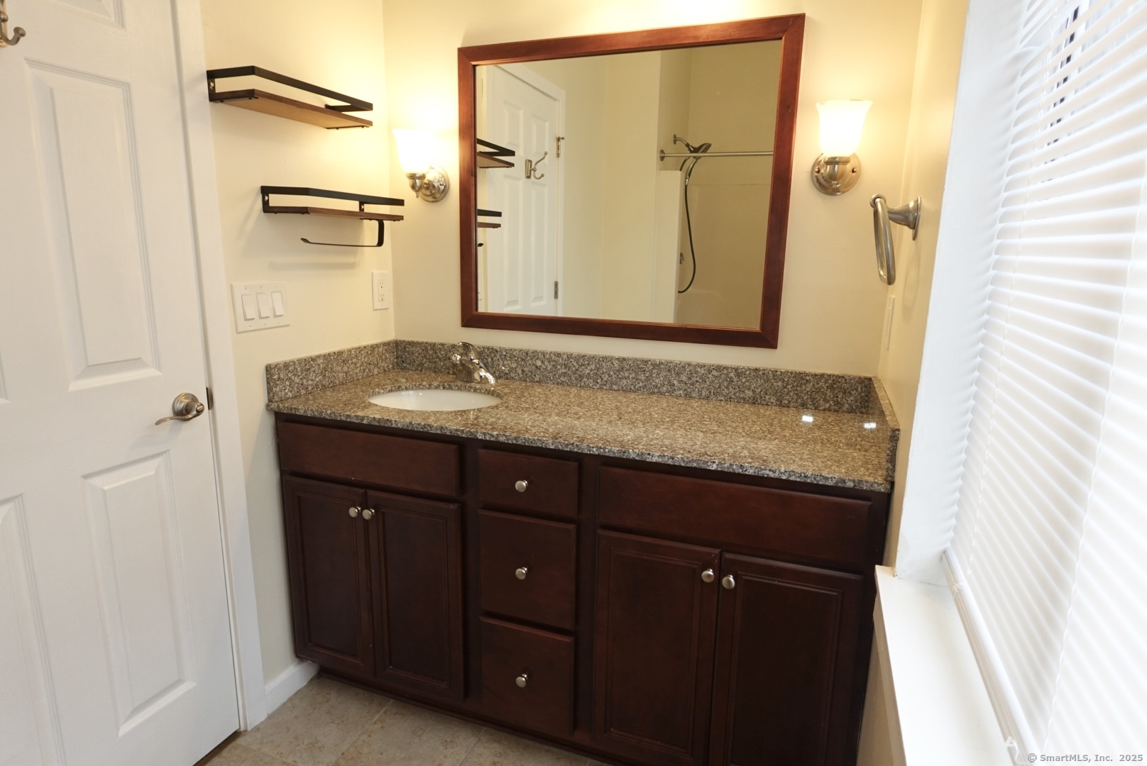 17 Pepperidge Court, Unit 17 Simsbury, CT 06070 - Photo 11 of 20 a bathroom with a granite countertop sink and a mirror