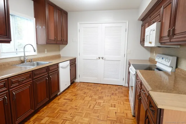 a kitchen with a sink stove and cabinets
