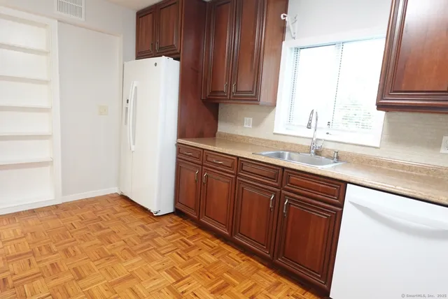 a kitchen with stainless steel appliances granite countertop a refrigerator and a sink