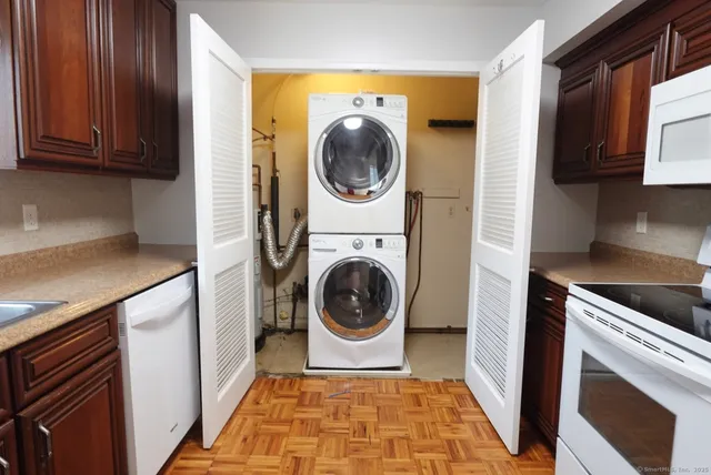 a utility room with sink dryer and washer