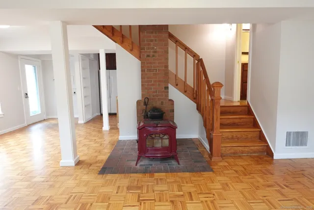 a view of entryway and hall with wooden floor