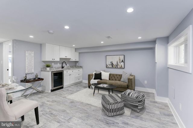 a living room with furniture and kitchen view