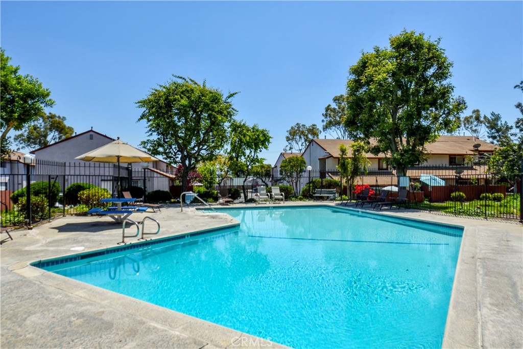 1709 Paramount Boulevard Montebello, CA 90640 - Photo 18 of 19 a view of a swimming pool with lawn chairs under an umbrella