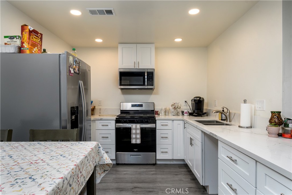 1709 Paramount Boulevard Montebello, CA 90640 - Photo 4 of 19 a kitchen with stainless steel appliances granite countertop a stove top oven a sink and dishwasher