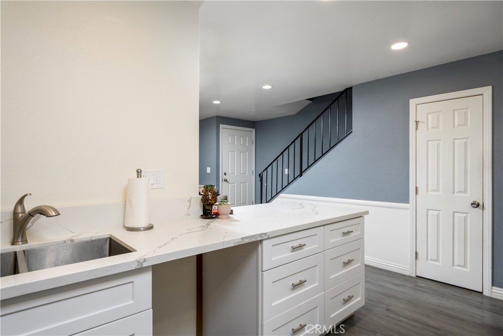 1709 Paramount Boulevard Montebello, CA 90640 - Photo 5 of 19 a view of a hallway to room with wooden floor