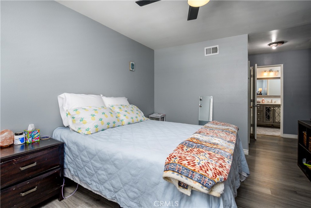 1709 Paramount Boulevard Montebello, CA 90640 - Photo 9 of 19 a bedroom with a bed and wooden floor