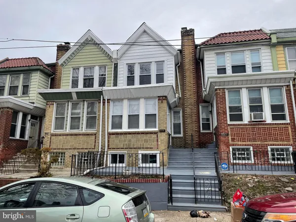 a front view of a residential apartment building with a yard