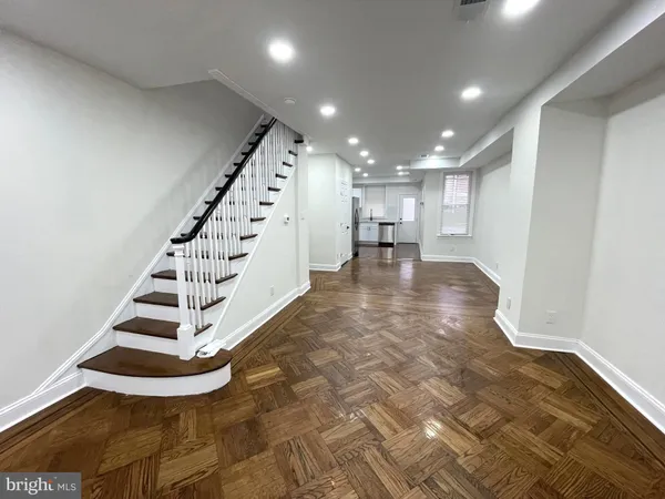 a view of entryway and hall with wooden floor