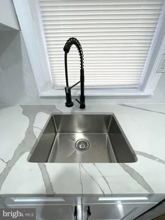 a stove top oven sitting inside of a kitchen